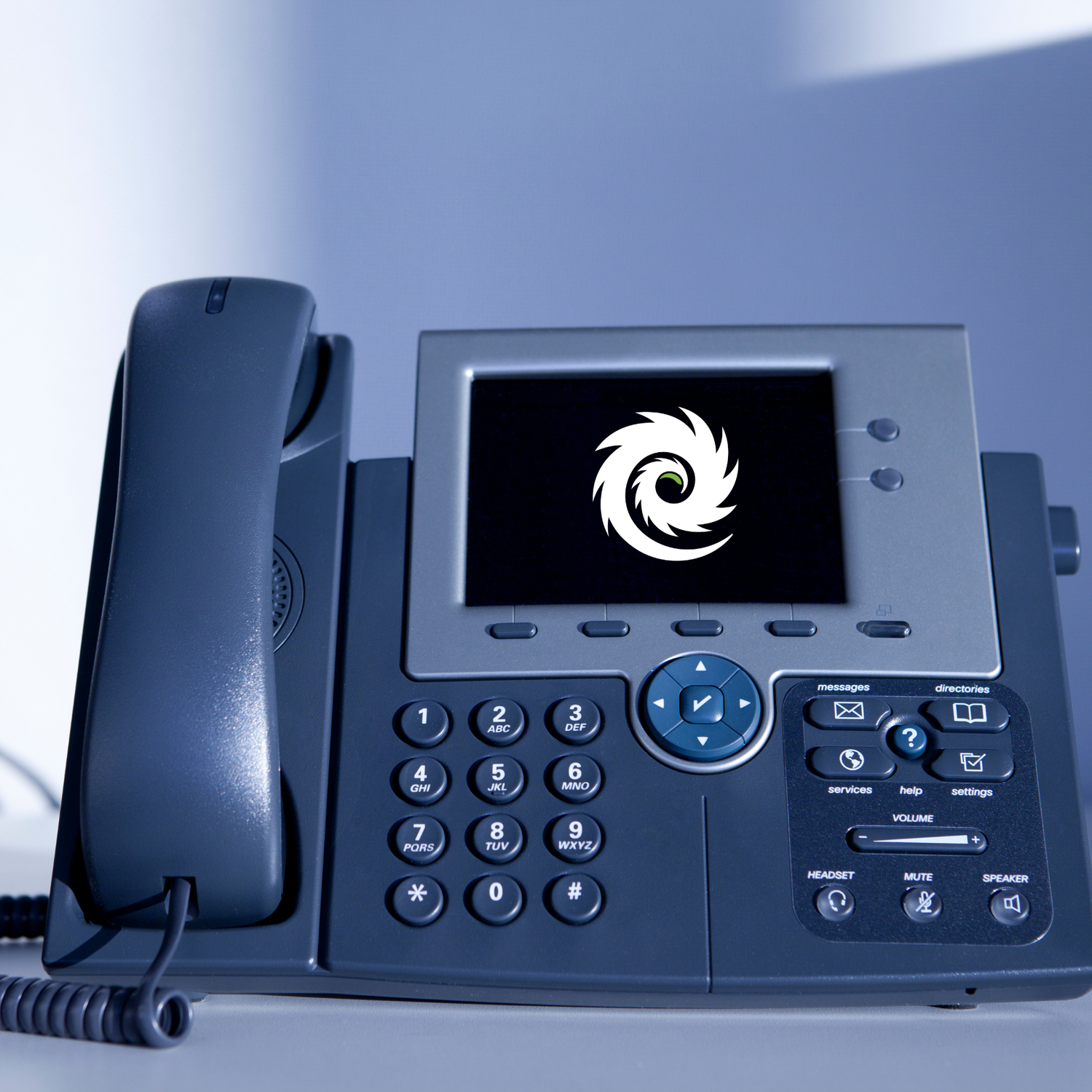Black office phone with digital display and keypad on a light blue background